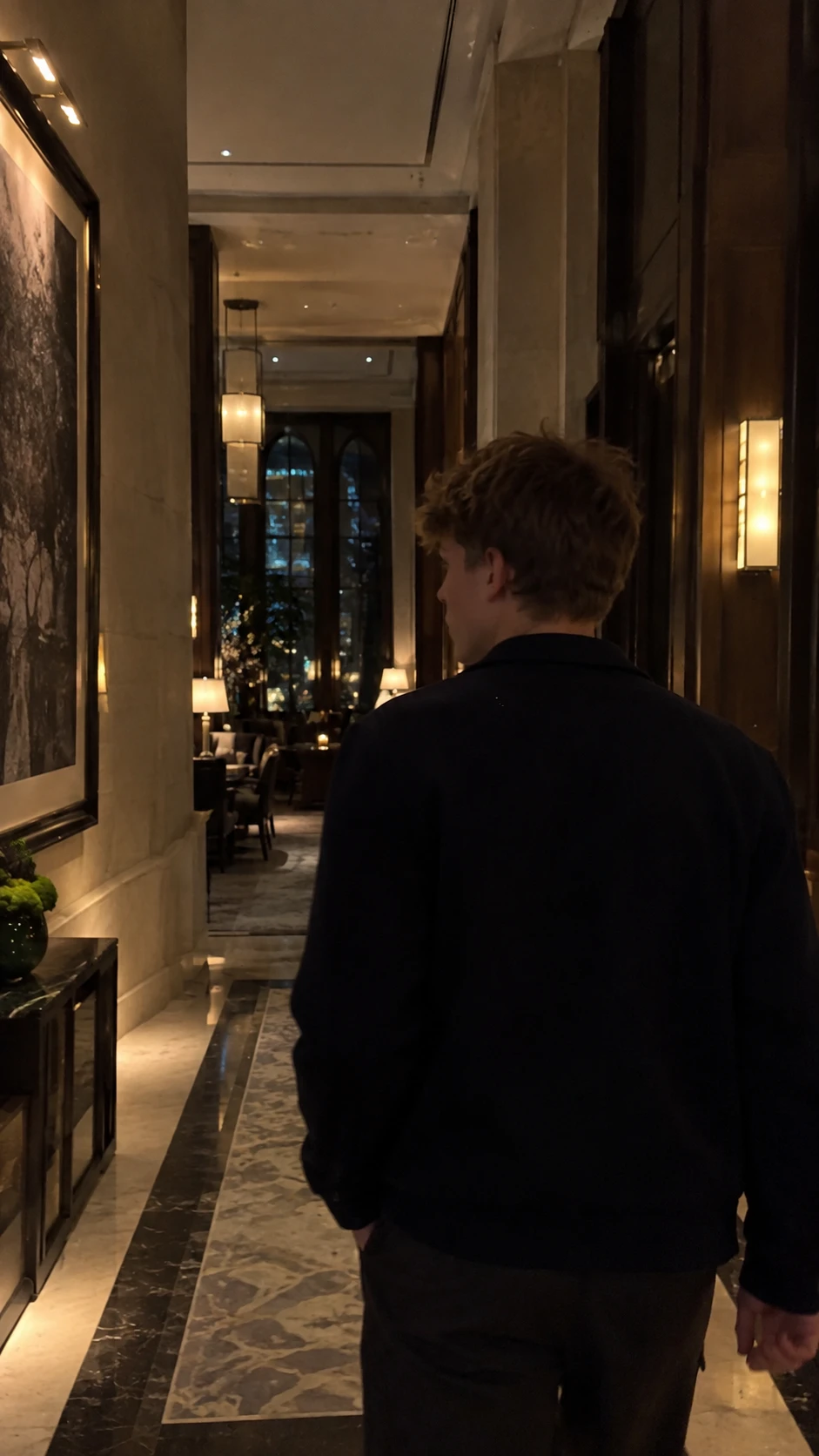 Camden Renninger walking through a hotel hallway at night